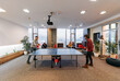 © .shock - Business colleagues take a break from work to enjoy a game of table tennis, fostering teamwork and camaraderie in the workplace
