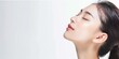 © MD Media - Beautiful Asian woman with perfect skin, portrait of beautiful young model posing on gray background with closed eyes and open mouth in profile, skin care concept, close up side view