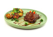 © patipas - Juicy steaks with potato garnish on a stylish green plate