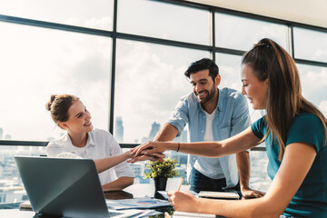 Wall Mural - Group of skilled businesspeople putting hands together at modern office.Happy smart business team working together. Represented unity, love, team, working together, partnership, work place. Tracery.