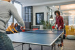 © .shock - Business colleagues take a break from work to enjoy a game of table tennis, fostering teamwork and camaraderie in the workplace