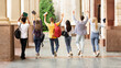 © Prostock-studio - Students walking in college campus after passing test, back view