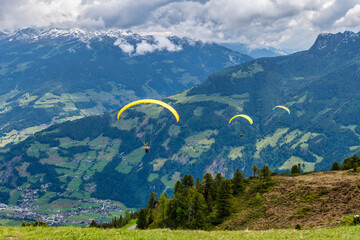 Paragliders and the mountains viewed from Penken Mountain in Mayrhofen in Austria, Europe