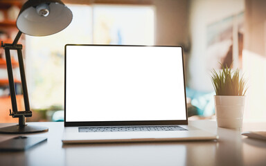 Wall Mural - laptop with a blank screen on a table in a bright home office. perfect for inserting your own conten