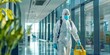 © YuDwi Studio - Disinfection Worker in Protective Gear Walking Through an Office Building