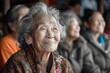 © marimalina - An elderly Asian woman smiles enthusiastically, closing her eyes in a hall with other spectators
