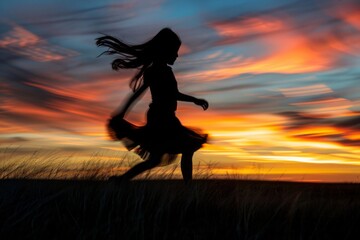 Wall Mural - Girl's silhouette captured in motion against a mesmerizing sunset.