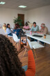 © ADDICTIVE STOCK - Diverse team in a business meeting captured on smartphone