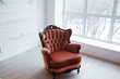 © sergiophoto - An elegant vintage armchair is in a bright living room