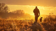 © Hoss - A hunter with his hunting dog walking in a field during the fall at golden hour. A bird dog and his master silhouetted against the sun.