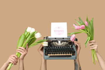Wall Mural - Hands holding vintage typewriter, tulips and festive postcard with text 8 MARCH WOMEN'S DAY on beige background
