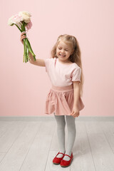 Sticker - Cute little girl with bouquet of beautiful ranunculus flowers near pink wall