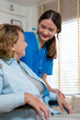 © Jirakul - Caring Nurse Assisting Elderly Woman at Home - Compassionate Home Care Services for Seniors