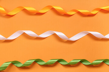 Satin ribbons in colors of Indian flag on orange background. Indian Independence Day