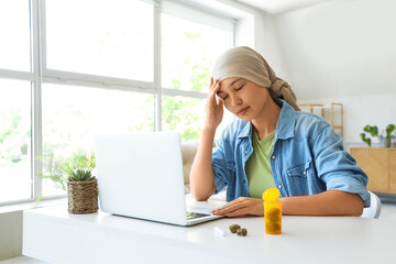 Sticker - Young Asian woman after chemotherapy with laptop and weed sitting at home