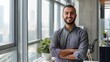 © Lucija - charismatic portrait of a smiling arab professional in smart casual attire standing confidently in a modern office space with floortoceiling windows and city views