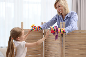 Canvas Print - Puppet theatre. Smiling mother and daughter performing show at home