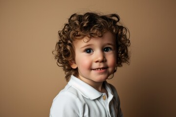 Sticker - Portrait of a cute little boy with curly hair. Studio shot.