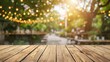 © Unic - Empty wooden table in summer background with the blurred green garden and party in the background.