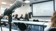 © buraratn - Microphone on a stand in front of a whiteboard with seminar participants taking notes