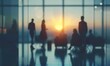 © wpw - Silhouette of business people having a meeting against a modern office background with blurred abstract elements.