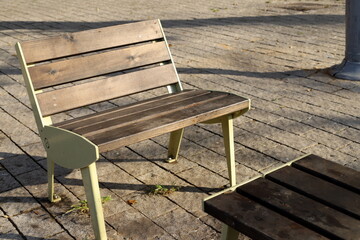 Wall Mural - A lounge chair stands on the sidewalk on a street in a big city.