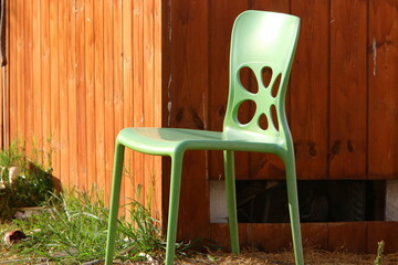 Wall Mural - A lounge chair stands on the sidewalk on a street in a big city.