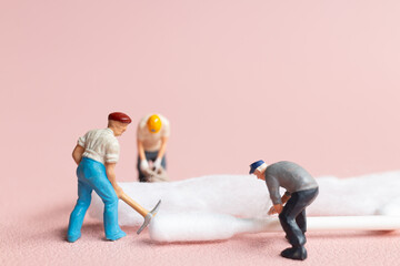 Wall Mural - Worker in action, meticulously crafting a cotton bud from raw cotton.highlighting the delicate craftsmanship involved in producing a common item.