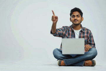 Sticker - young indian man using laptop and pointing