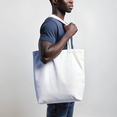 Tote bag mockup. Young African American man carrying reusable cotton linen eco organic fabric canvas blank totebag on white background. AI generated