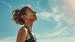 © radekcho - Fitness woman runner resting and breathing with happiness against blue sky.