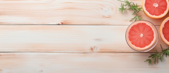 Aufkleber - Top-down view of a delicious grapefruit beverage with ice, garnished with rosemary and fruits, set on a light wooden table, providing space for a text overlay image. with copy space image