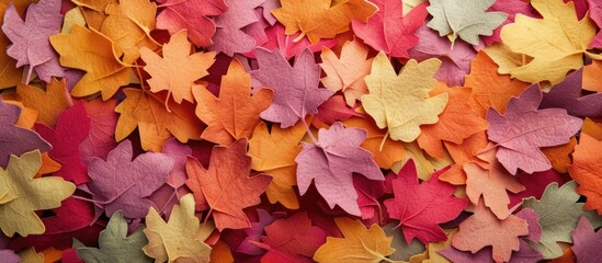 Wall Mural - Background in autumn shades featuring colorful felt leaves for a copy space image.