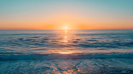 Wall Mural - The ocean is calm and the sun is setting, creating a beautiful