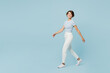 © ViDi Studio - Full body side view young smiling happy cheerful woman wears striped t-shirt casual clothes walk go look camera isolated on plain pastel light blue cyan background studio portrait. Lifestyle concept.