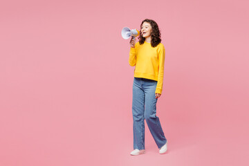 Wall Mural - Full body young woman wearing yellow sweatshirt casual clothes hold in hand megaphone scream announces discounts sale Hurry up isolated on plain pastel light pink background studio. Lifestyle concept.