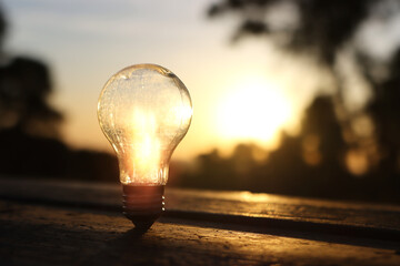 Wall Mural - energy and business concept image. Creative idea and innovation. light bulb metaphor in front of the sun