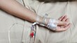 © Rung Kh - Portrait patient lying on the bed, Saline in hand and during lying rehabilitation in the hospital, health care and medical concept.