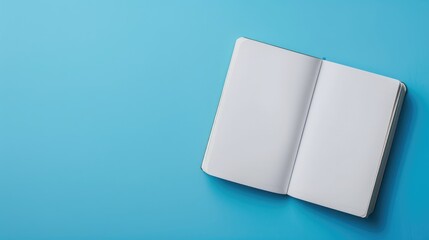 Poster - Top view of open notebook on blue background for customization Represents business office or education