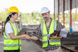 © JU.STOCKER - Engineers shaking hands at construction site, Construction workers handshake with factory foreman workers at the precast concrete factory site
