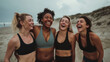 © BB_Stock - Group of female friends with different body types standing and laughing together on a beach in workout clothes