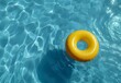 © MD - Yellow Inflatable Ring Floating in Blue Pool Water