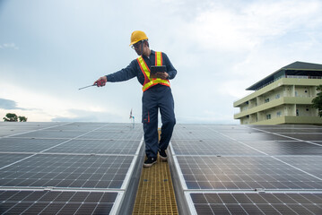 Wall Mural - a solar panel installation company employee assembles a photovoltaic system on the roof.
