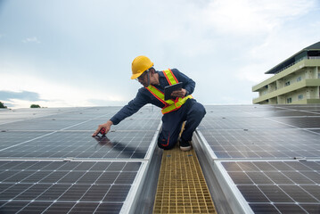 Wall Mural - A solar panel installation company employee assembles a photovoltaic system on the roof.