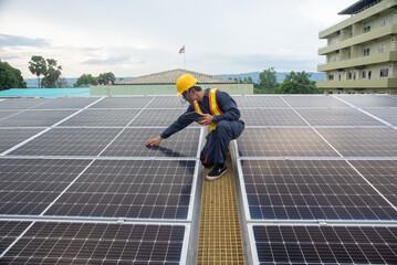 Wall Mural - a solar panel installation company employee assembles a photovoltaic system on the roof.