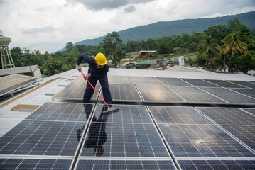 Wall Mural - cleaning staff solar panels are making up the photovoltaic system on the roof.