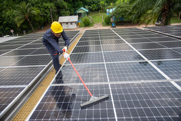 Wall Mural - cleaning staff solar panels are making up the photovoltaic system on the roof.