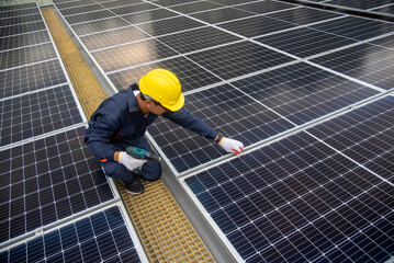 Wall Mural - workers installing solar panels are building a photovoltaic system on the roof.