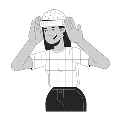Wall Mural - Joyful arab woman wearing warm hat black and white 2D line cartoon character. Middle eastern female trying on accessory isolated vector outline person. Fashion monochromatic flat spot illustration