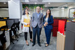 © GAJENDRRA BHATI  - Senior Indian businessman with his colleagues standing in corporate office looking at camera. entrepreneur and workplace concept.